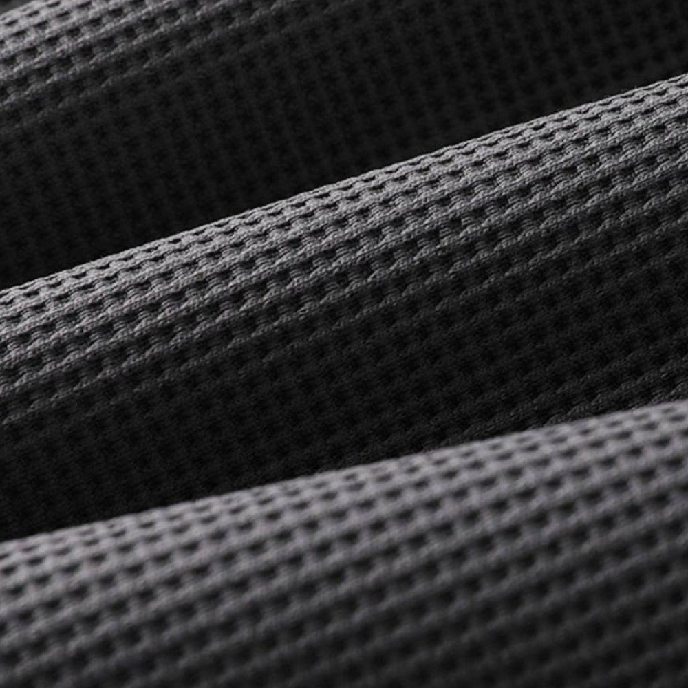 Donkergrijze, geribbelde stoftextuur close-up, ideaal voor modeontwerp en interieurdecoratie. Hoogwaardige textielstructuur, modern en stijlvol.